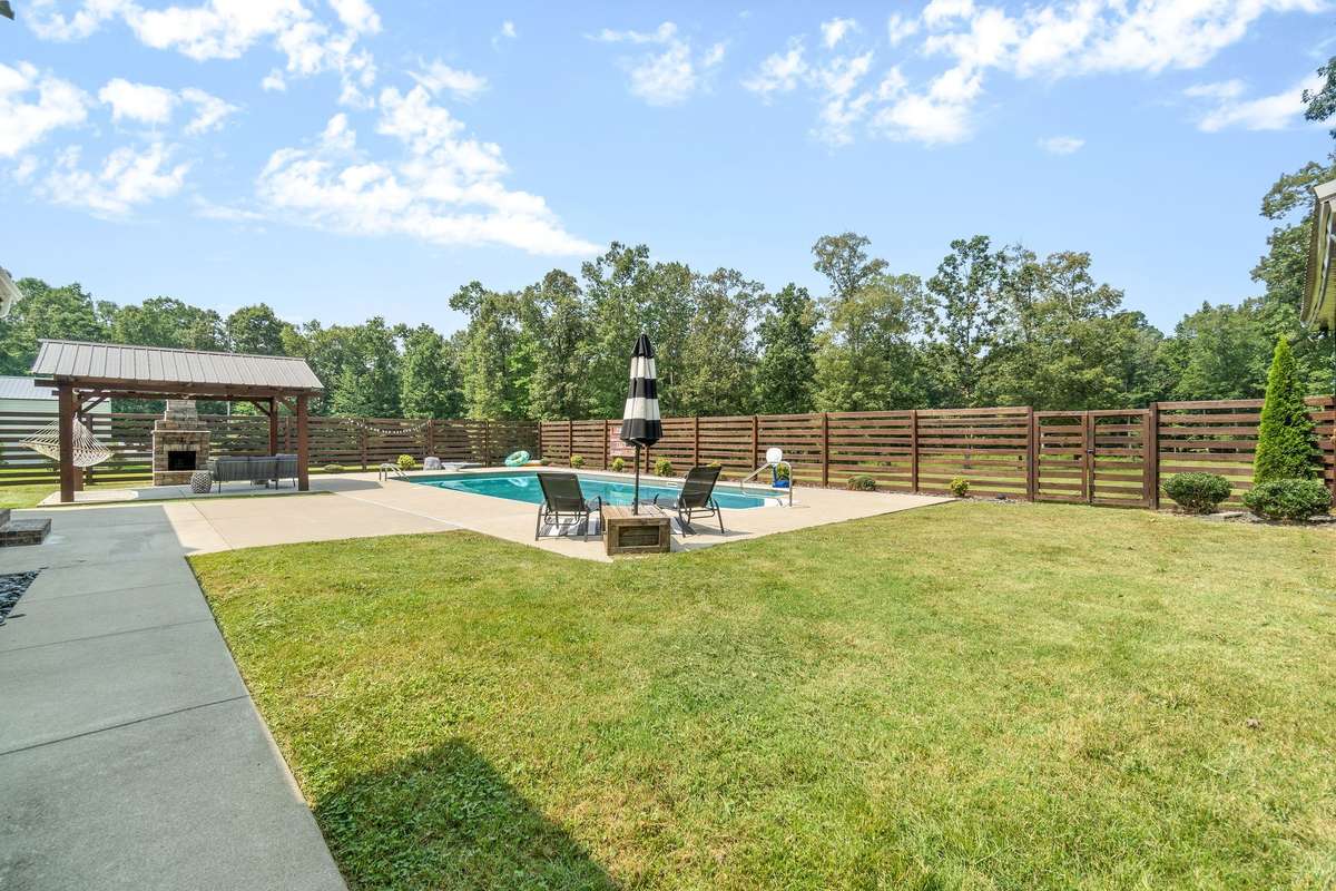 Fenced in back yard with pool, with plenty of yard outside of fence as well