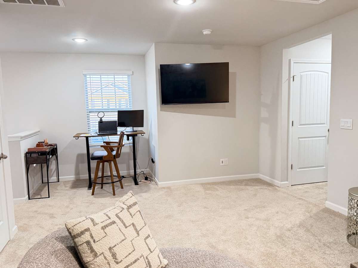 The office area of the upstairs Loft area is to the left. We will get another photo of the other side of the room. This room has a couch & loveseat & a swivel chair and still plenty of space to move around.