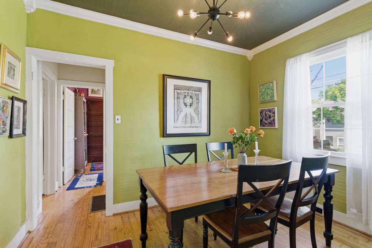 The dining room looks out over the lush green side yard.