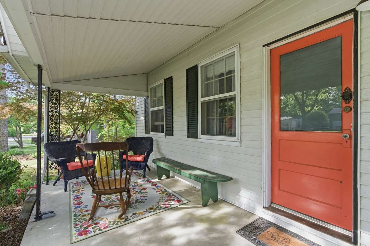 The inviting front porch is framed by the landscaping touches in the front yard
