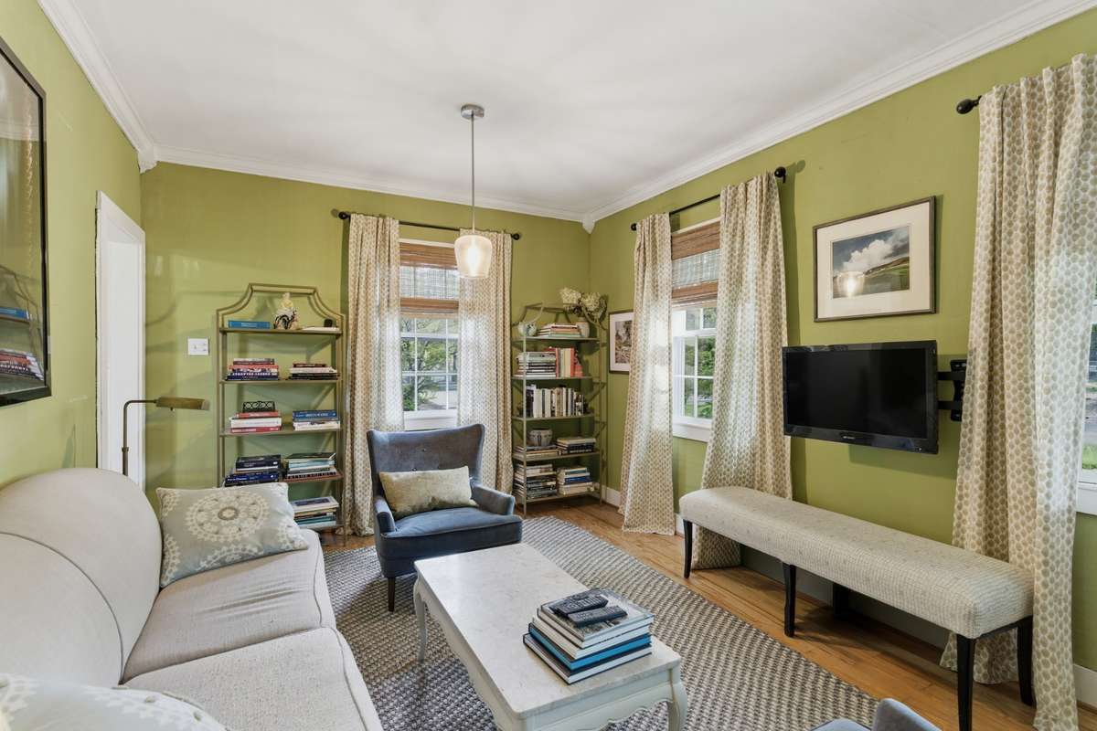 This cozy living room has lots of natural light and hardwood floors.