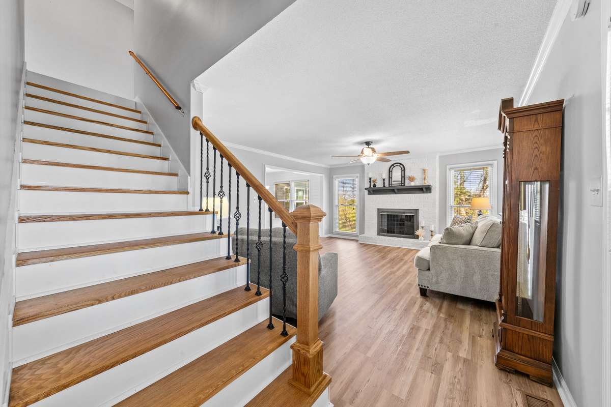 Stairs leading to 2nd story with 2 more bedrooms and a full bath.