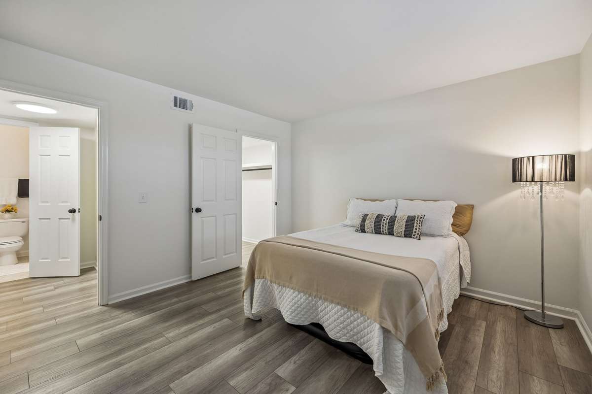Primary bedroom with closet and laundry room in view
