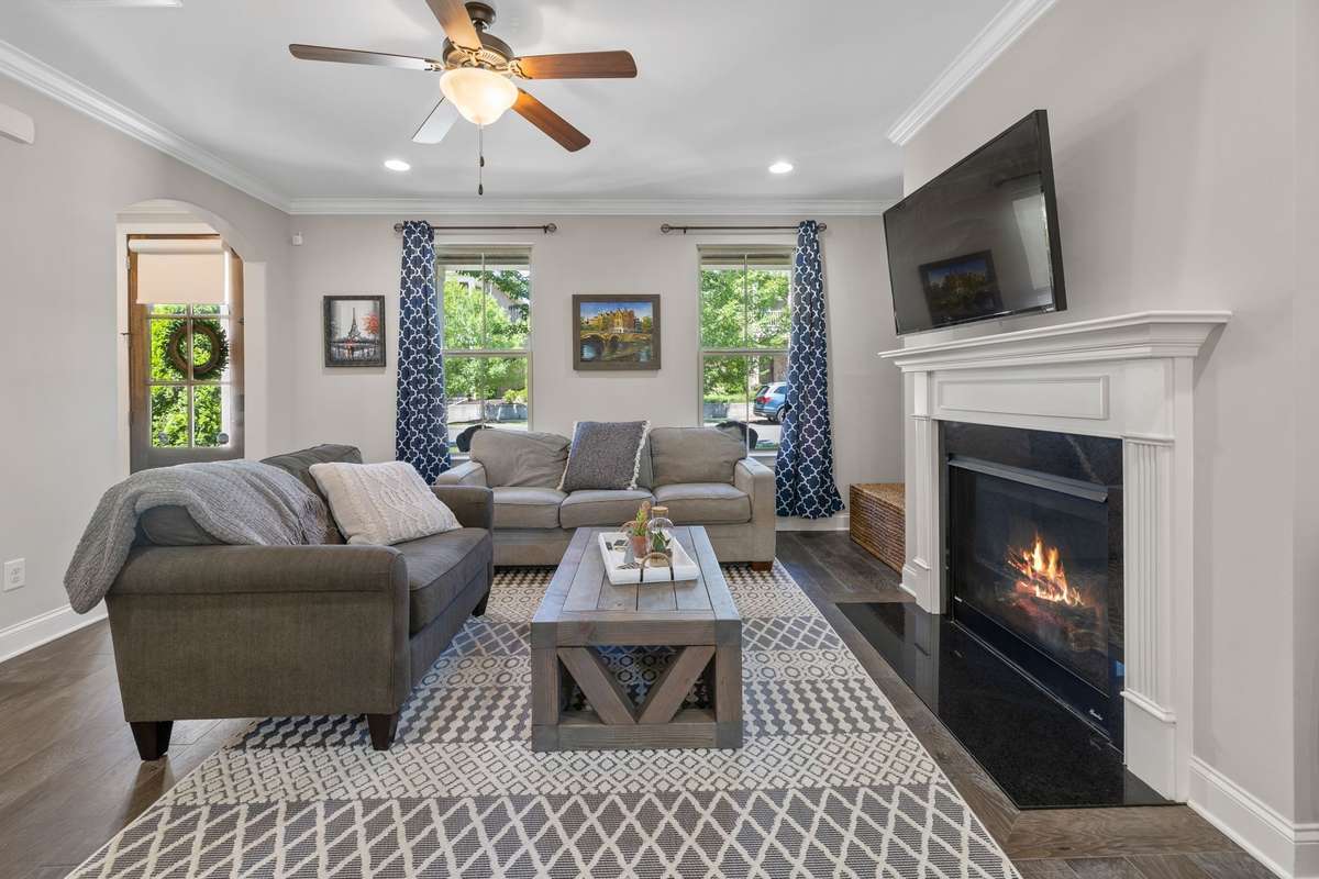 Gorgeous cozy Living Room with custom touches - crown mold, hardwoods on main floor, gas fireplace (great as a secondary heat source). Lovely crown moulding and hardwoods downstairs.  Powder room conveniently located adjacent to living room.