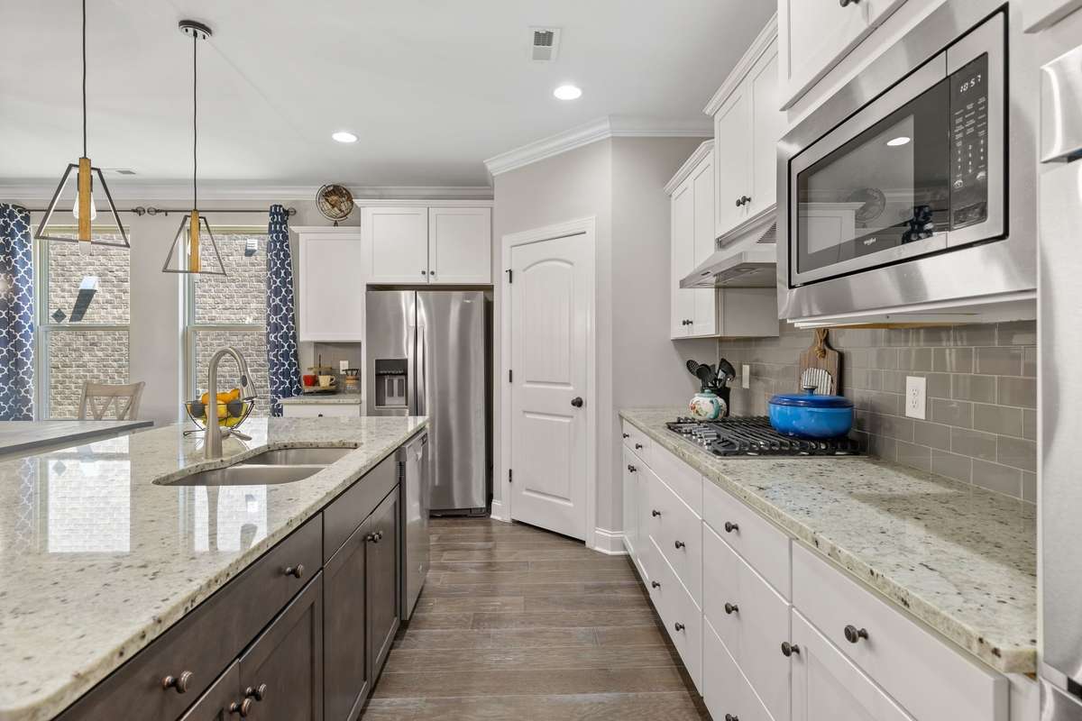 Granite! Stainless! Granite! Stainless appliances!  Pantry!!! Gas cooktop! Double Oven! Upper mounted Microwave! Undermount sink!  Chef-inspired Kitchen.