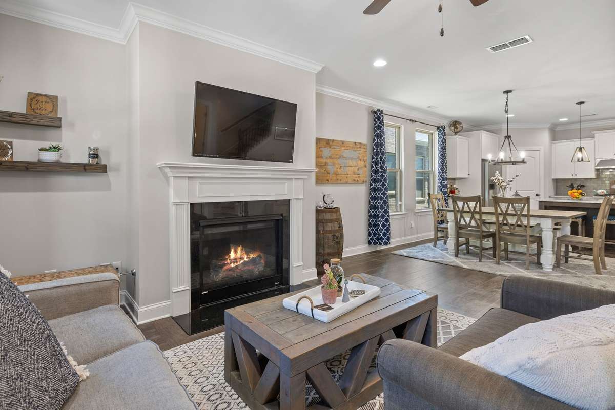 Charming architectural features iin this Living Room include crown mould, a fireplace, hardwoods and a ceiling fan.  Powder room is located just off the living room.