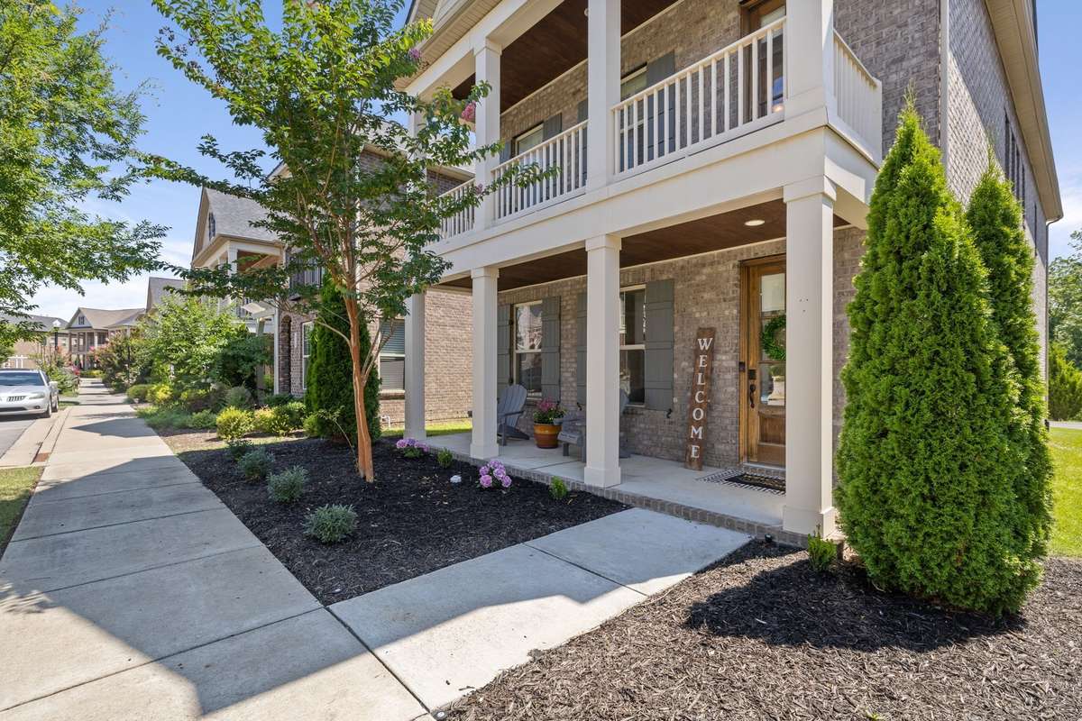 Exterior elevation shows a full length second story balcony which creates a prominent and classic entrance, while providing shaded outdoor space on two levels.