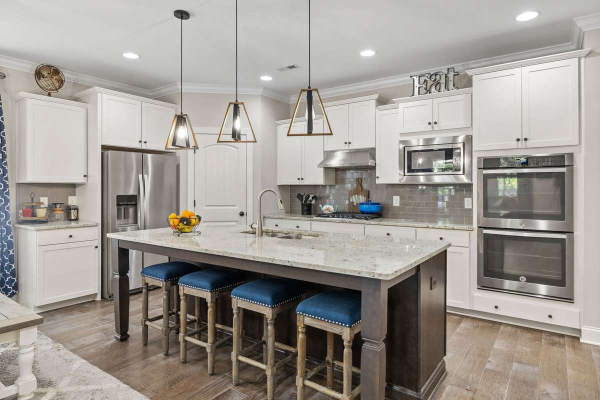 This island Kitchen is the heart of the home. Whether you cook or not, this Chef-inspired  kitchen offers a gas cooktop, double oven, upper mounted microwave, pantry and granite.  It's the perfect place to gather.