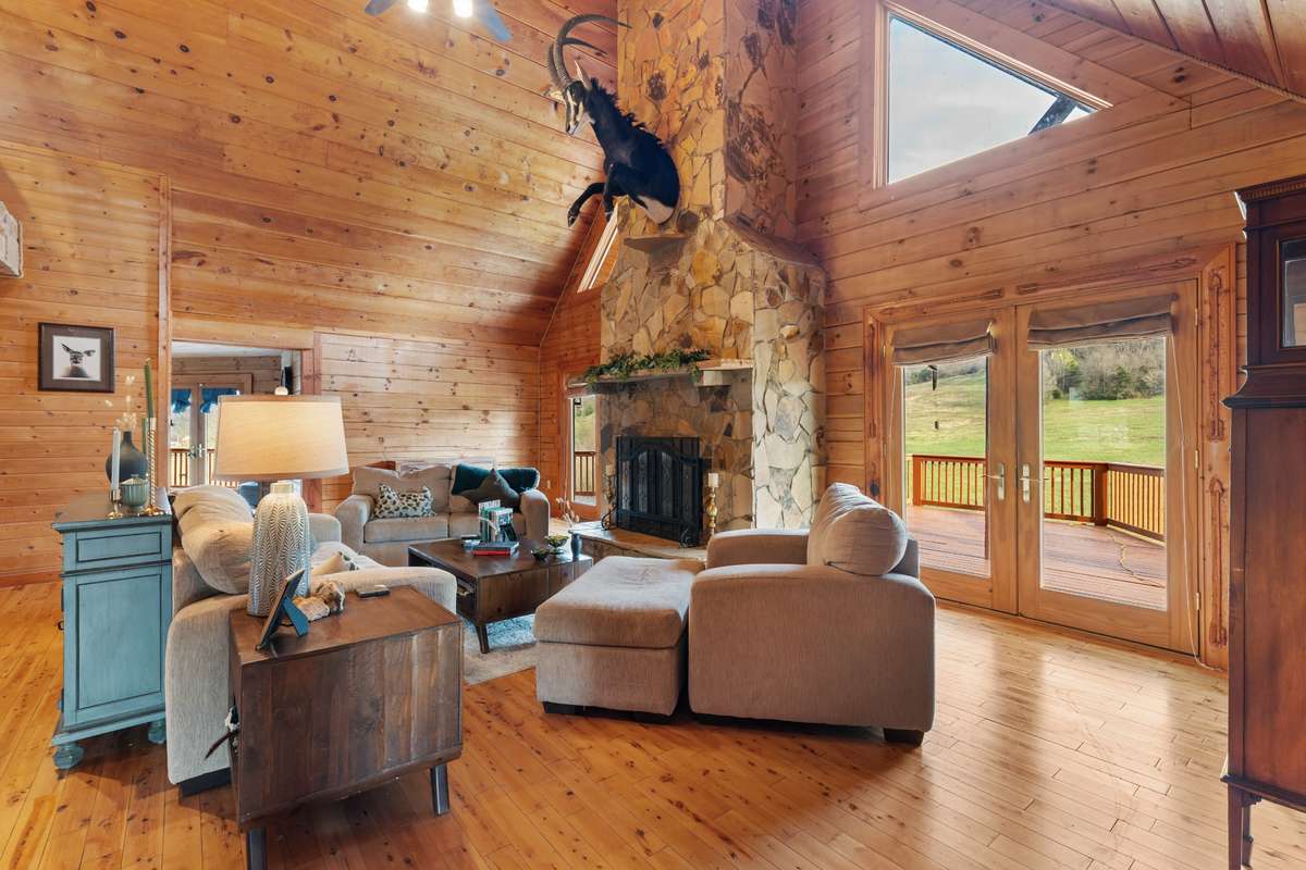 Stone stacked 2 story fireplace is the focal point of the living room.