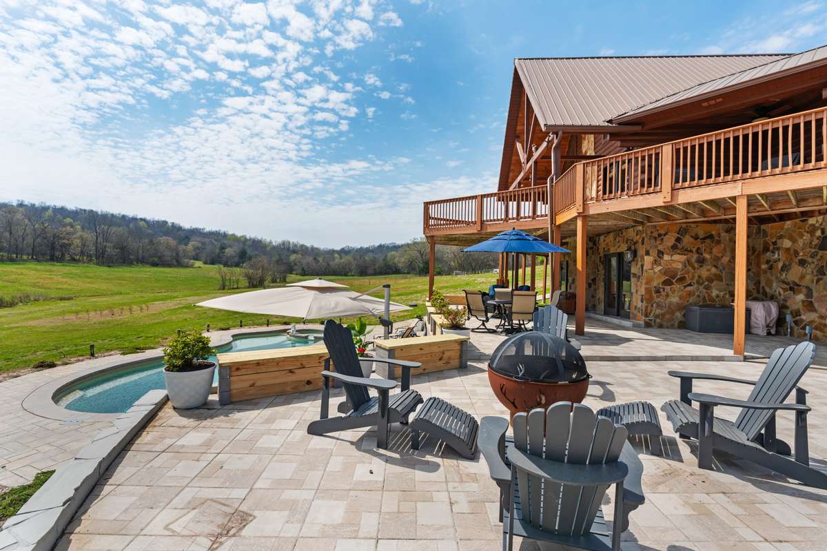 Fire pit gathering area pool and patio side for ease to entertain.