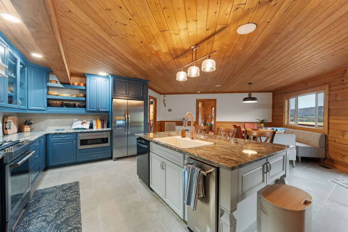 Island storage on all four sides, farmhouse sink and all stainless steel appliances.