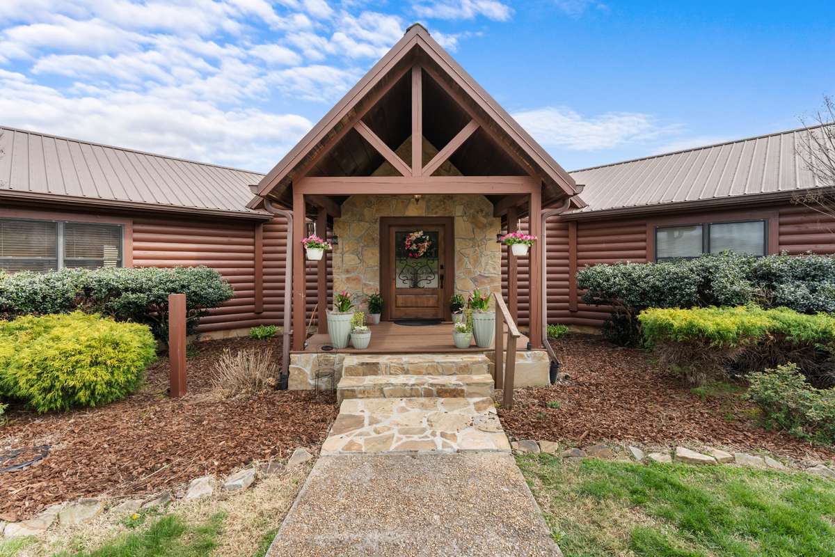This oversized covered porch and custom wood and iron entry door greet guests.