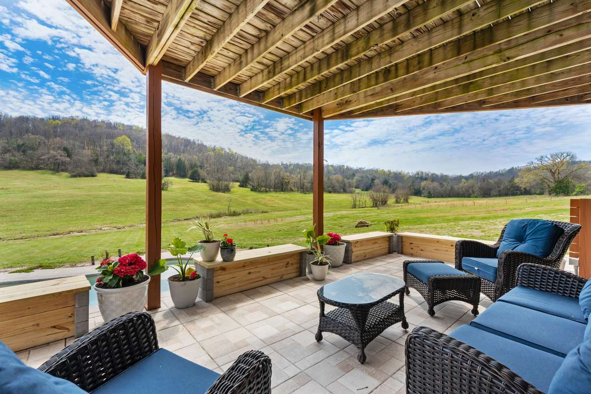 Basement covered porch patio area offering spacious seating room and the most magical view.