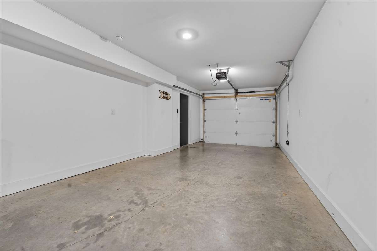 Plenty of space remains for parking, with room for two vehicles and convenient interior access directly into the home.