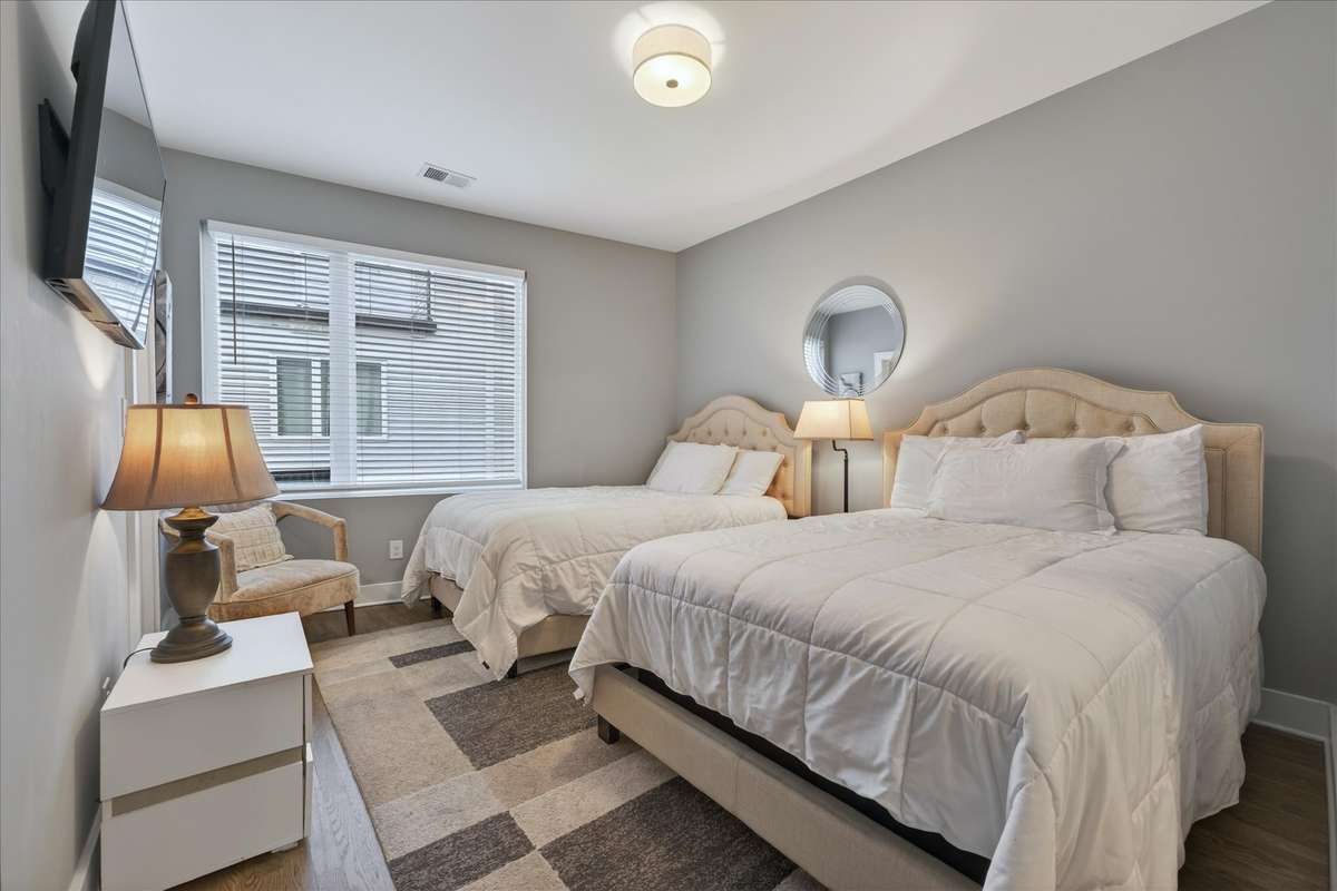 Bedroom 2 is spacious with two queen beds, a large walk-in closet, and its own ensuite bath, offers flexibility and comfort.