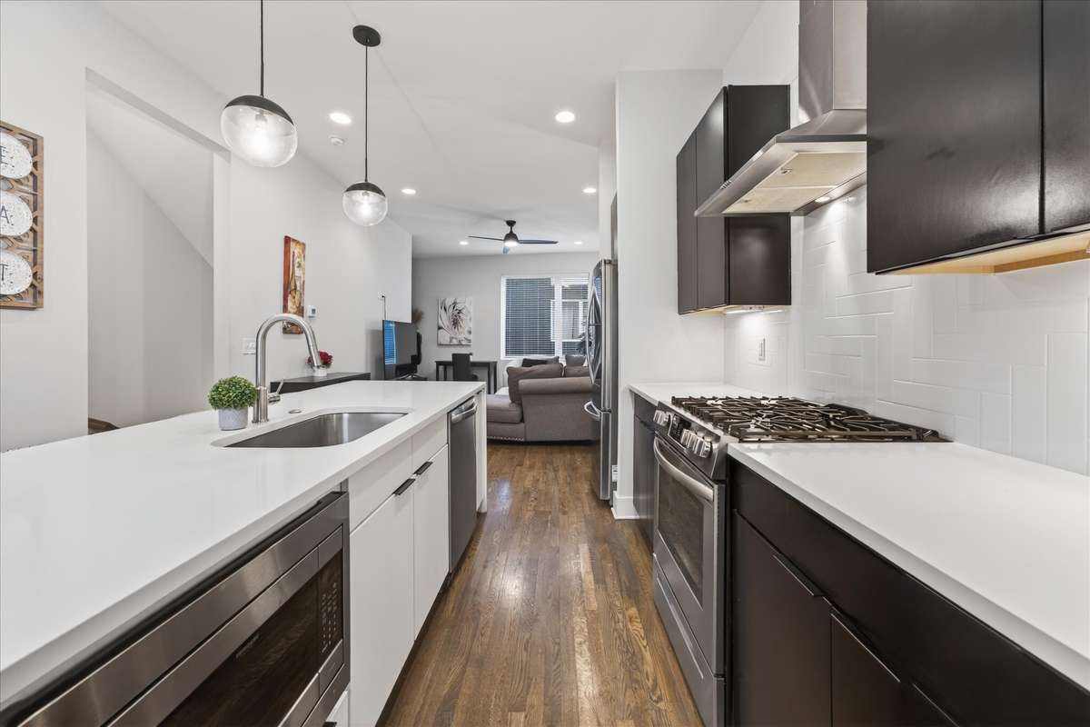 This sleek, modern kitchen is a chef’s dream—featuring a gas stove, smart fridge with a knock-to-light panel, dishwasher, and microwave—perfect for hosting and a standout feature for your Airbnb guests