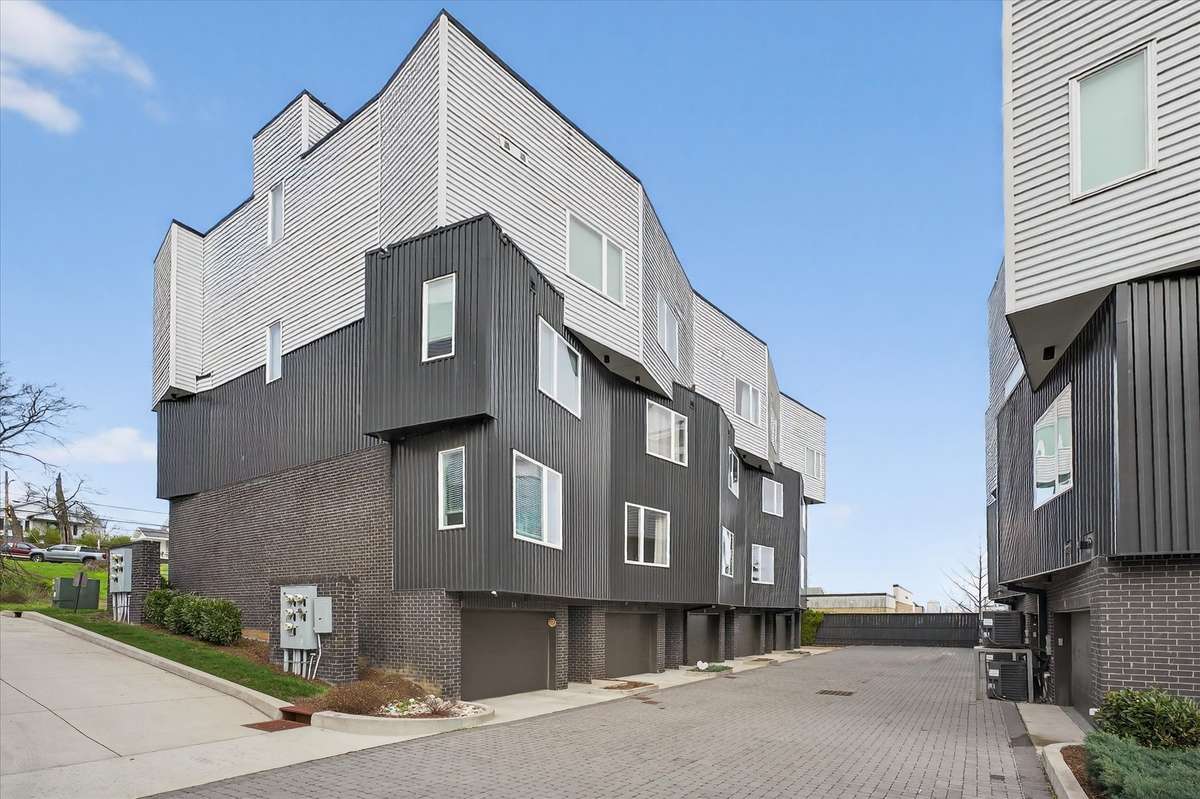 From this angle, you’ll see the convenient alley entrance—perfect for quick access to your garage, mailboxes, and a peaceful retreat from the street.