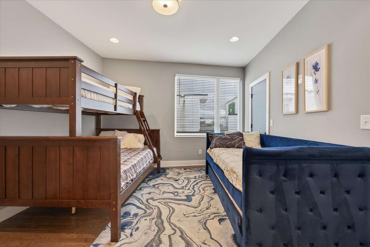 Bedroom 4 is designed with hosting in mind—featuring a spacious bunk setup with multiple full-size beds and a convenient pull-out trundle, comfortably accommodating larger groups.