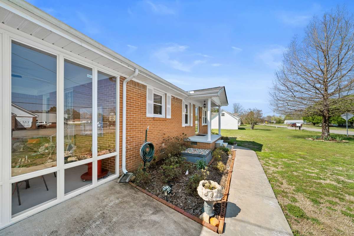 This photo has been altered with AI.  The brand new sunroom is incomplete.  The front windows were not installed.  Due to be complete April 14.
