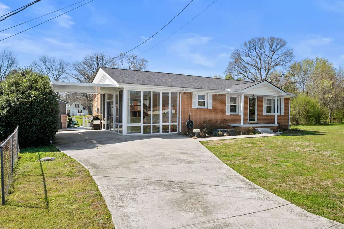 This photo has been altered with AI.  The brand new sunroom is incomplete.  The front windows were not installed.  Due to be complete April 14.