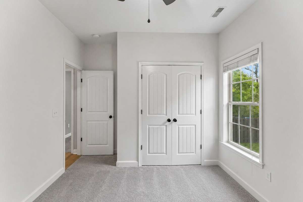 Third bedroom with large closet, ceiling fan, & carpet flooring. 1012 Rudder Drive, Spring Hill, TN 37174