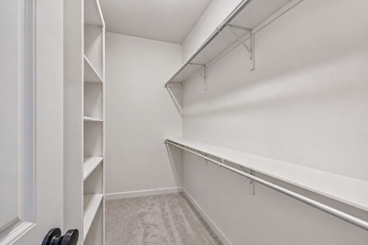 Primary walk in closet with ample storage & custom shelving. 1012 Rudder Drive, Spring Hill, TN 37174