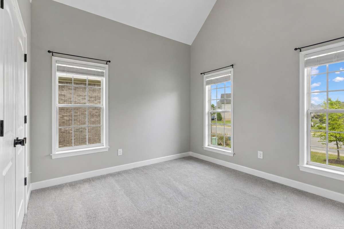 Second bedroom with several windows providing great natural lighting & carpet flooring. 1012 Rudder Drive, Spring Hill, TN 37174