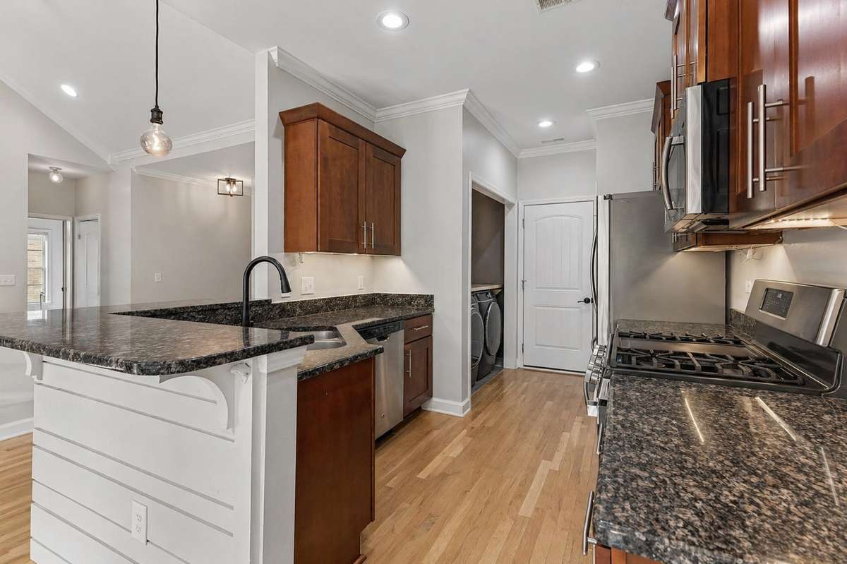 Large kitchen with wet bar, crown molding, & SS appliances. 1012 Rudder Drive, Spring Hill, TN 37174
