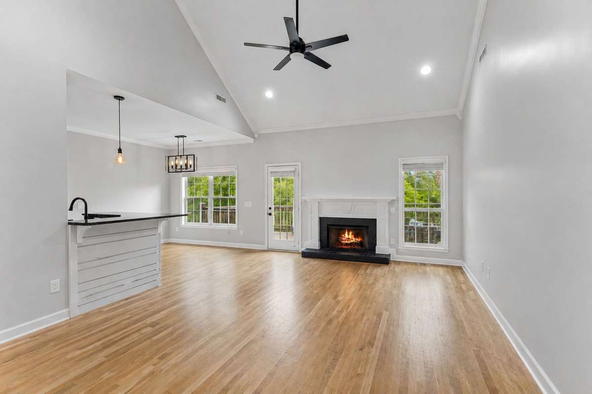 Large living room with two windows, recessed lights, & crown molding. 1012 Rudder Drive, Spring Hill, TN 37174