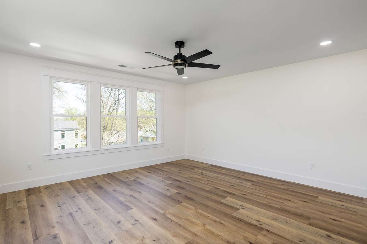 Large primary bedroom located in the rear of the home