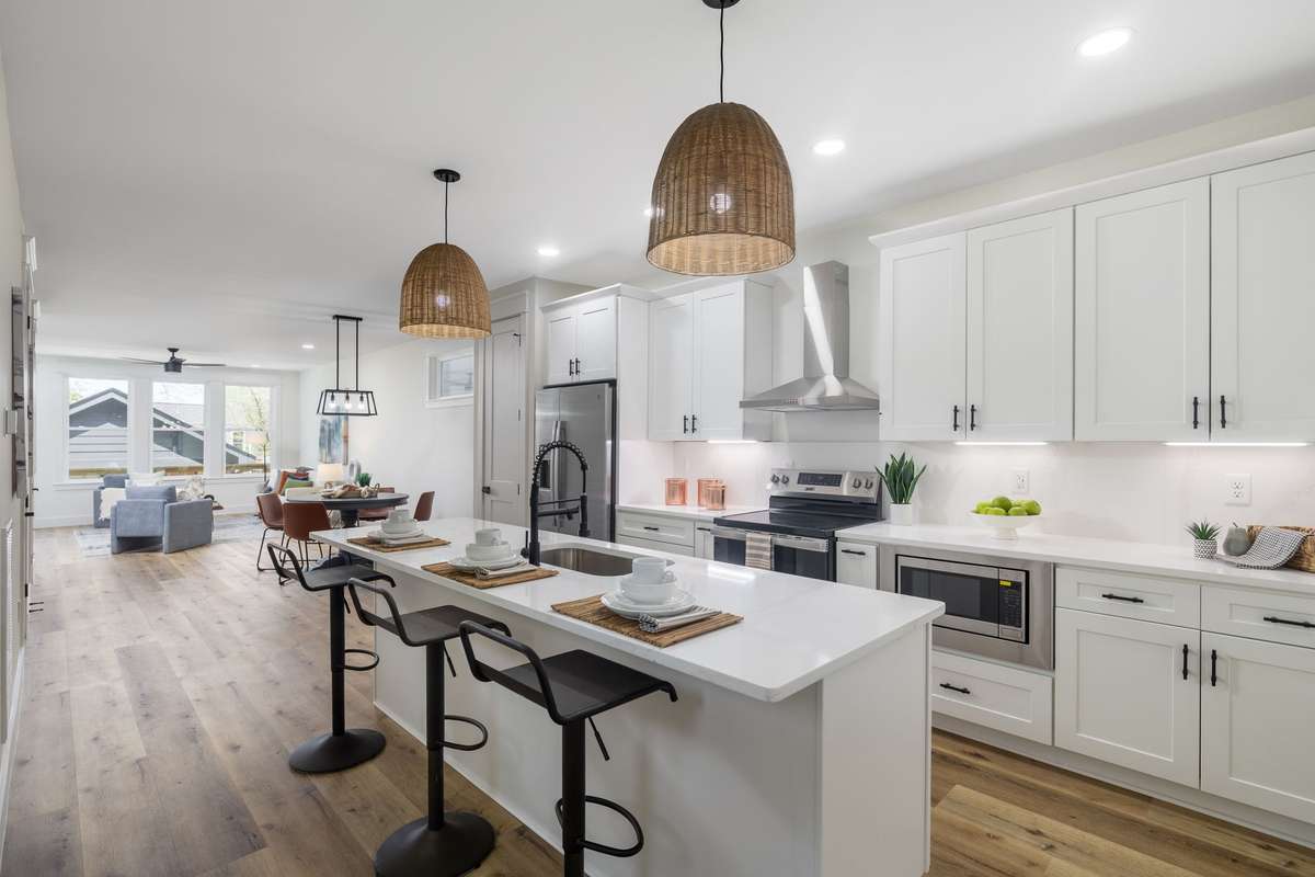 Perfectly planned kitchen with stainless steel appliances makes meal prep enjoyable and easy.