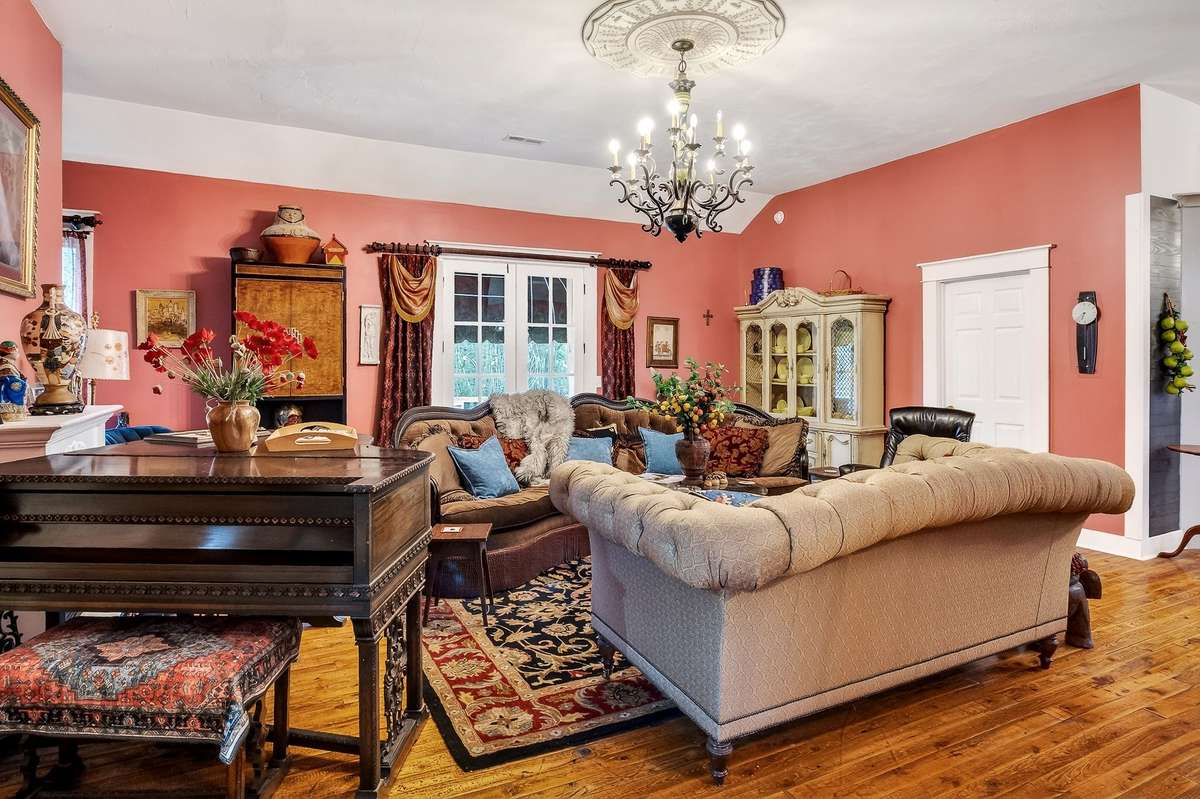 The top half, 2400 square feet living space, features this beautiful great room with tall ceilings and antique chandeliers. This room measures 22.8 x 21