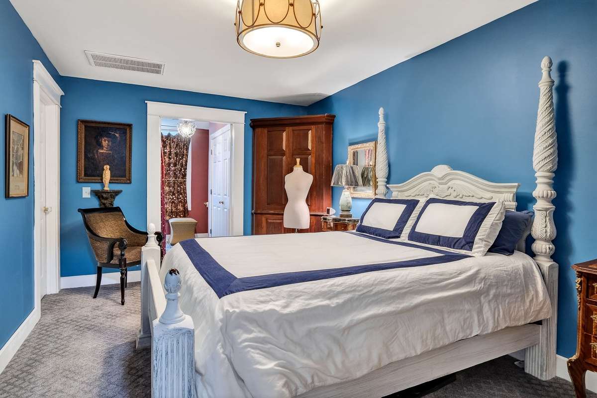 The back foyer leads directly into a guest room with a beautiful guest bath.