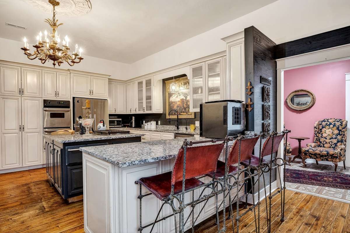 Leather bar stools to remain. This kitchen/dining leads into a back foyer