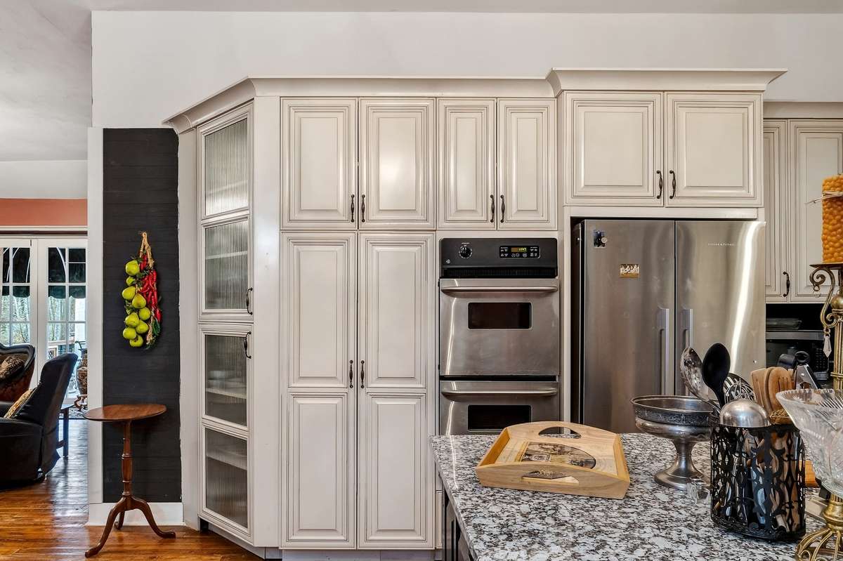 To the left of the double ovens is a built in (slide out) pantry. These cabinets came from a home in a gated community in Atlanta.