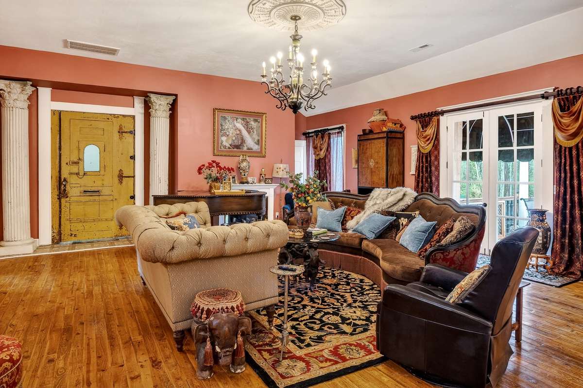 To the right of this living space are a set of eight foot French doors opening up onto a 12 x 24 treaded deck. There is a large awning over the doors. The 2 columns at entry do stay.