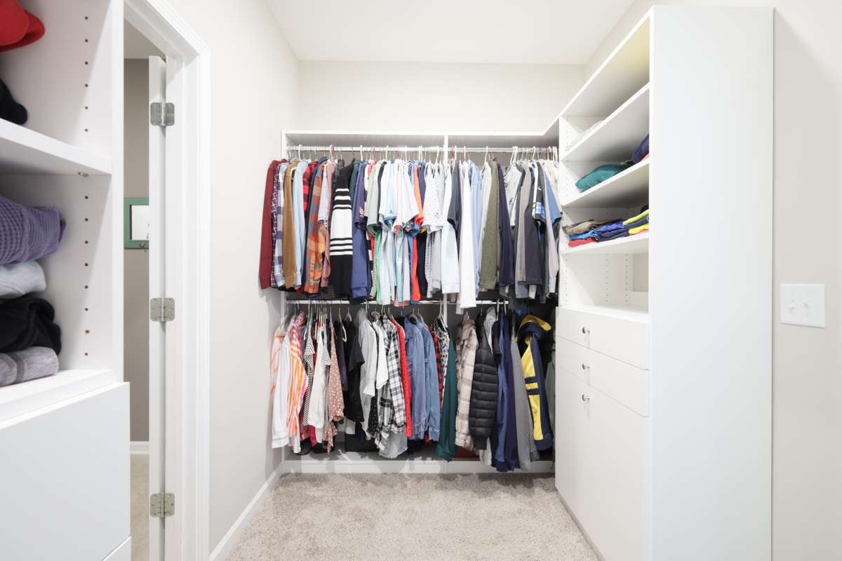Large walk-in closet with custom drawers and shelving added here as well.