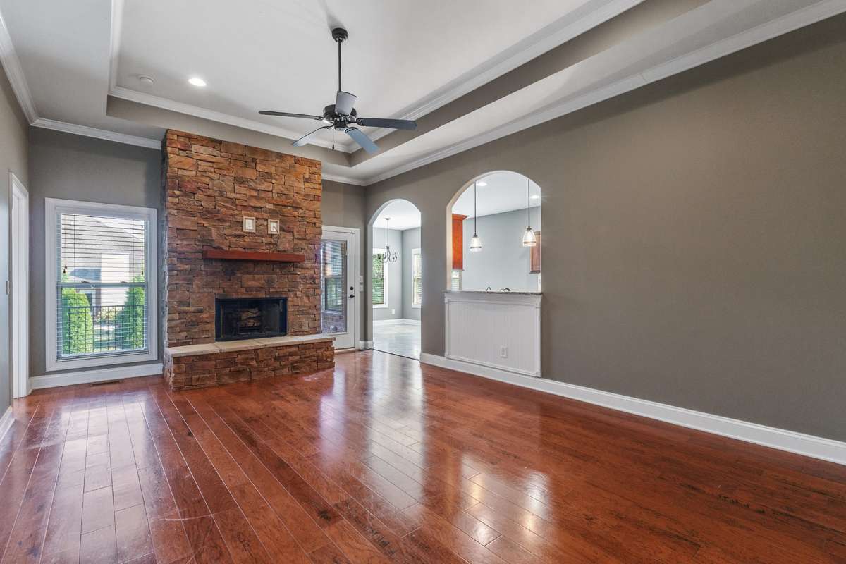 Floor to ceiling fireplace flanked by window and exit to covered patio