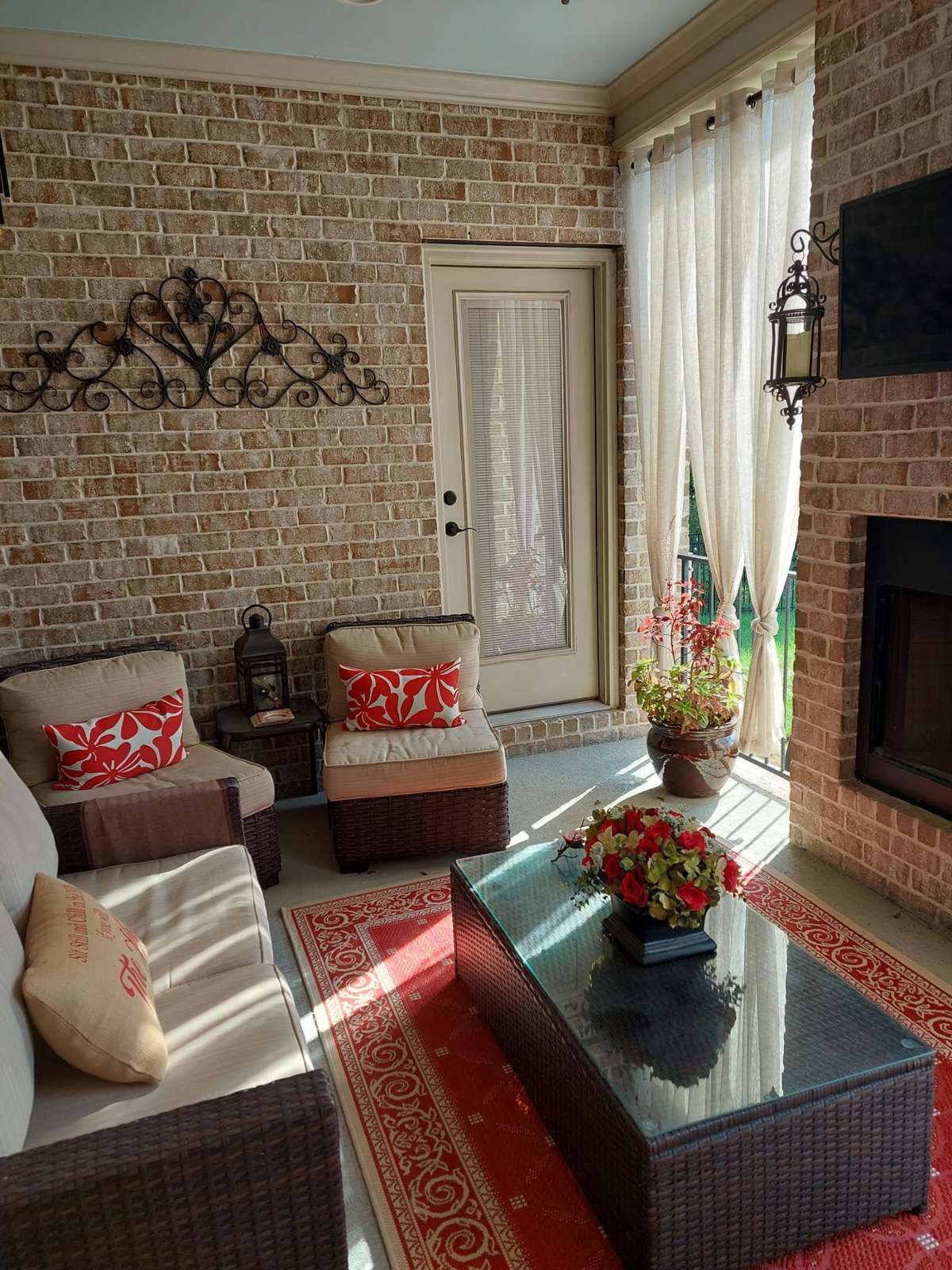 Entertain in style on the covered patio, equipped with a gas log fireplace and mounted TV, overlooking the backyard and green space. (photo is of previously staged area only)