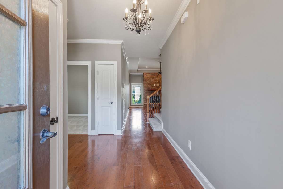 Rich hardwood floors greet you at the entry, setting a warm and inviting tone for the home.