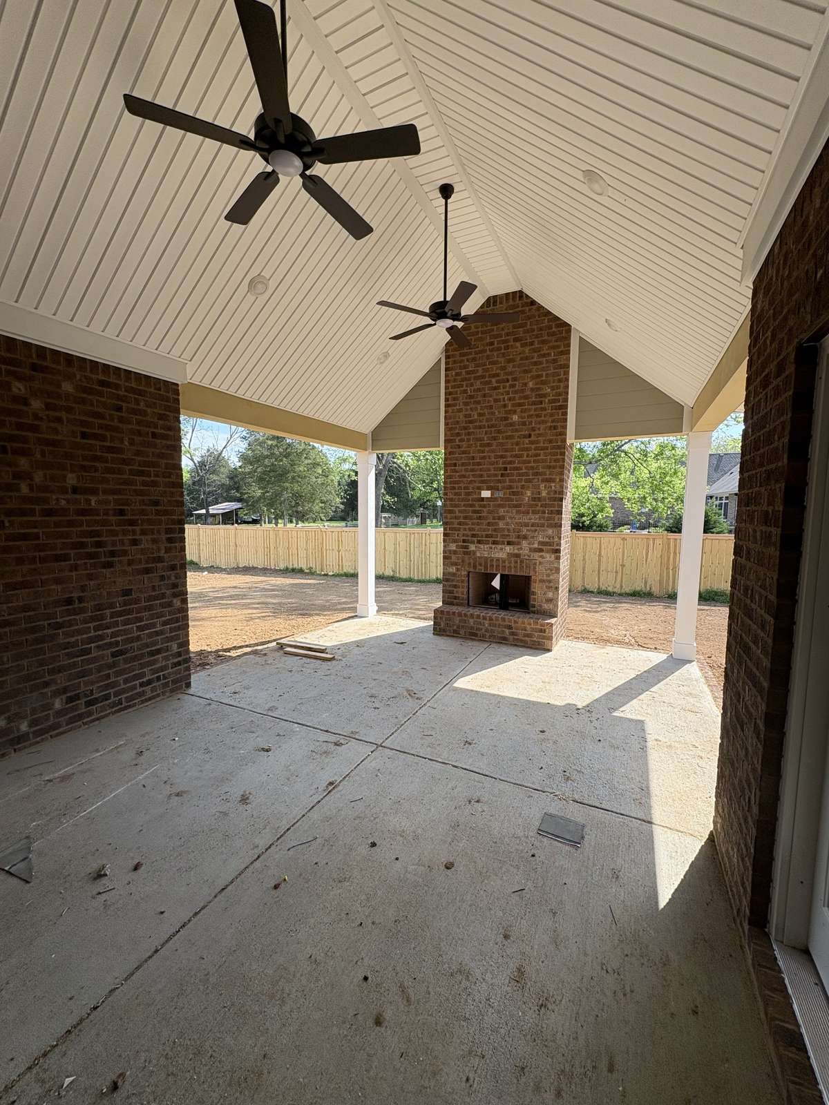 Jumbo Patio with cathedral ceiling and elaborate bricked fireplace center piece.
