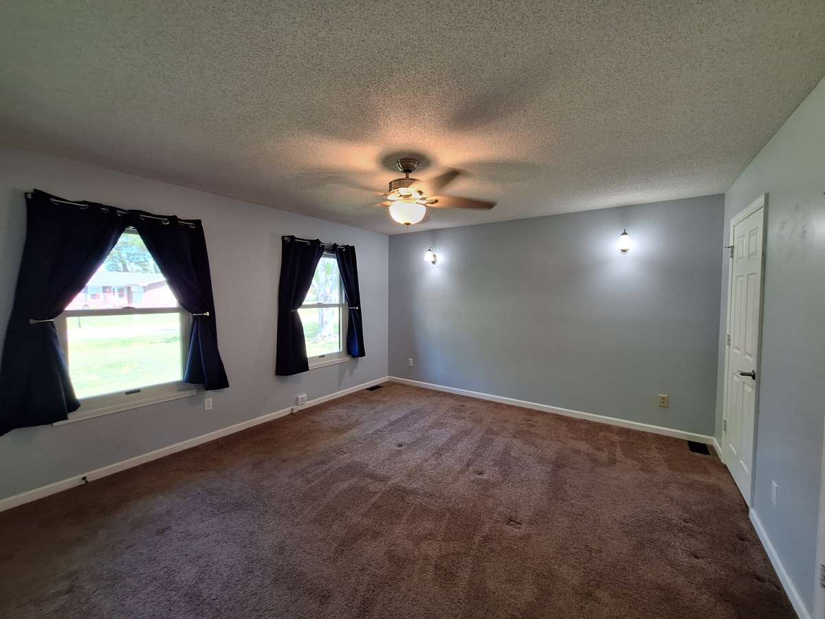 Spacious master bedroom with that calming blue color paint!!