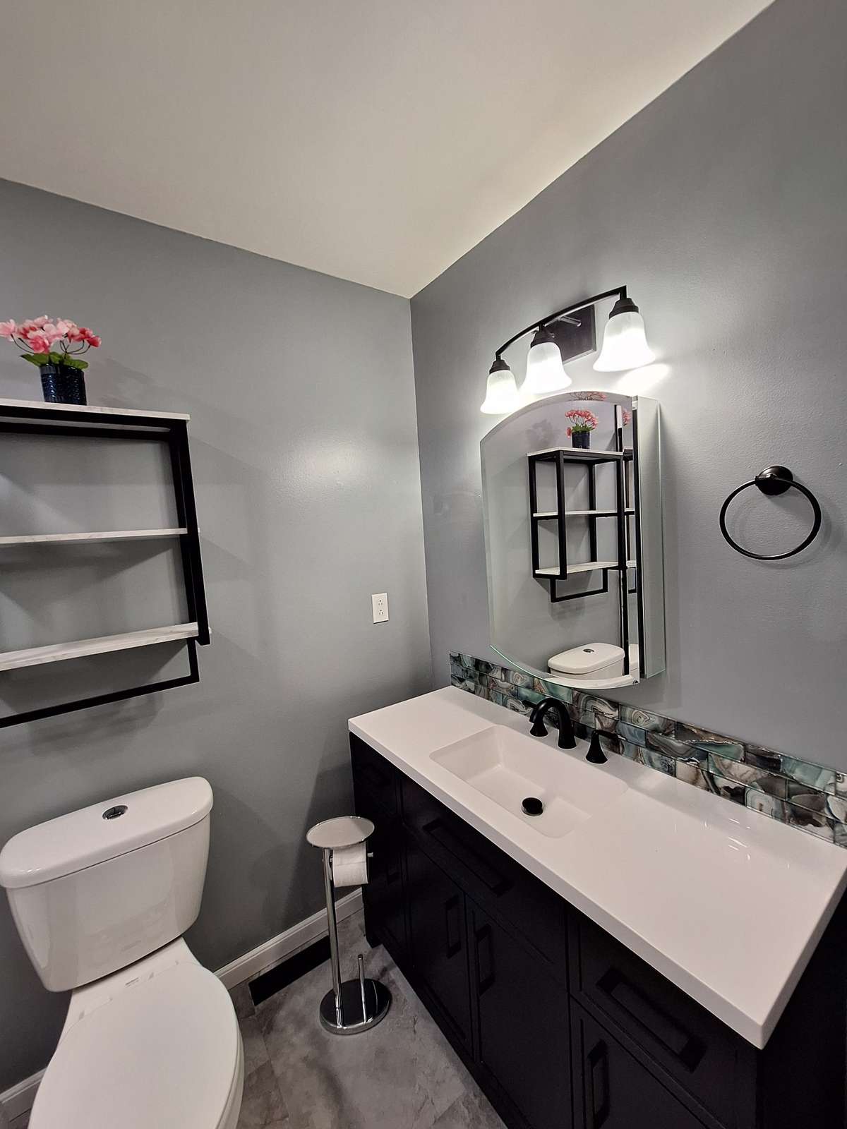 Cute vanity with the tile backsplash in the master bathroom!!