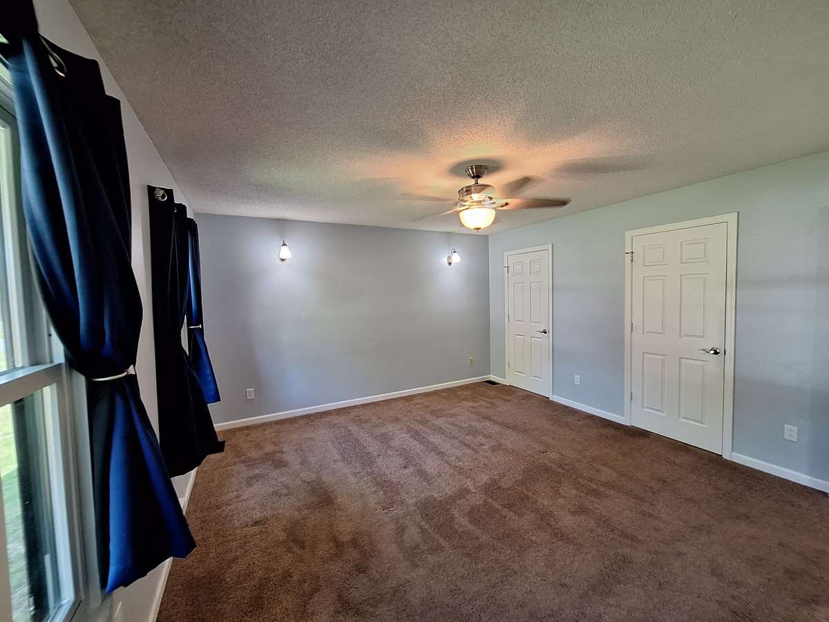 Master Bedroom that boasts of his and her closets!!
