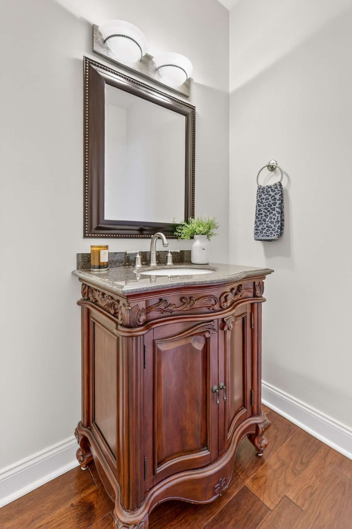 Powder Bath downstairs is lovely with it's custom vanity and wood floors.