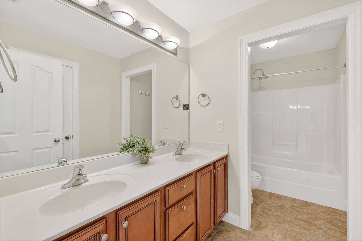 Full Bath Upstairs has Double Sinks, Separate Toilet and Shower Room. Also, a nice amount of cabinets for storage as well.