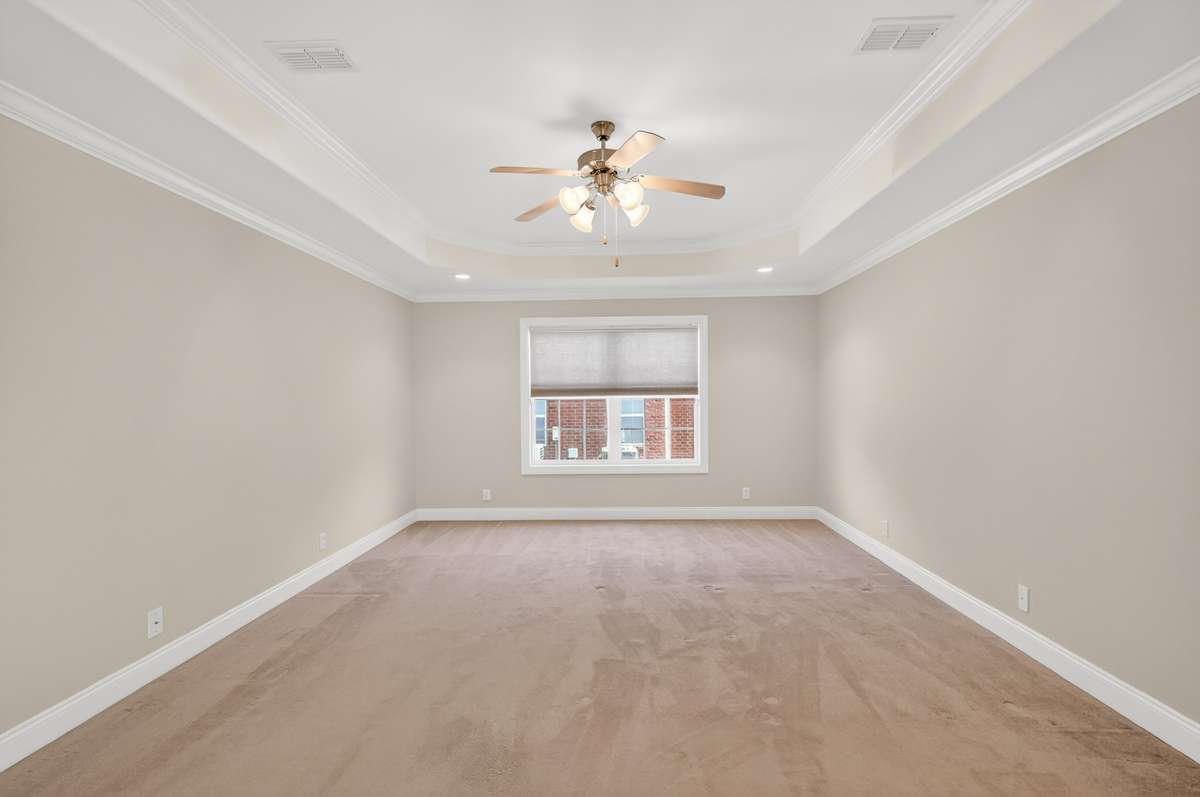 Look at the SIZE of this Primary Bedroom on the Main Floor.  Ceiling Fan and additional Recessed lighting provides the opportunity to customize the amount of light you want in your room.