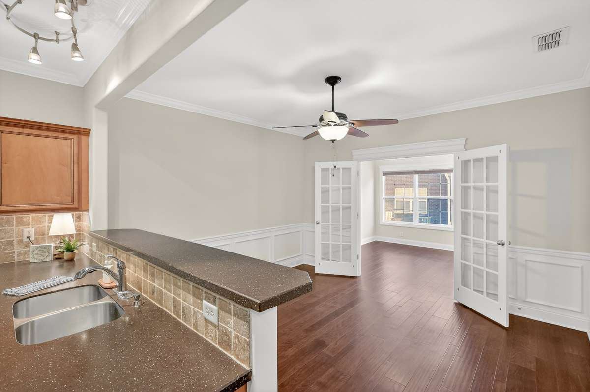 View from Kitchen into Dining Area and on into the 4 Season Room a.k.a. Office, Den, Exercise or Hobby Room.  The possibilities are endless.  Double doors add privacy to the room.