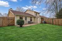 The spacious back yard is ready for summer fun or having your pets run! (Grass digitally enhanced.)