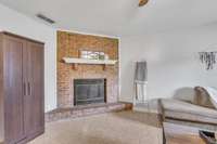 The beautiful brick fireplace surround is something you don't find in newer condos these days.